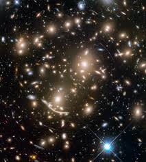 As seen by the Hubble Space Telescope, the galaxy cluster Abell 370 reveals telltale streaks of light from more distant galaxies that have had their light bent and distorted by an effect called gravitational lensing.  NASA, ESA, AND J. LOTZ AND THE HFF TEAM/STSCI